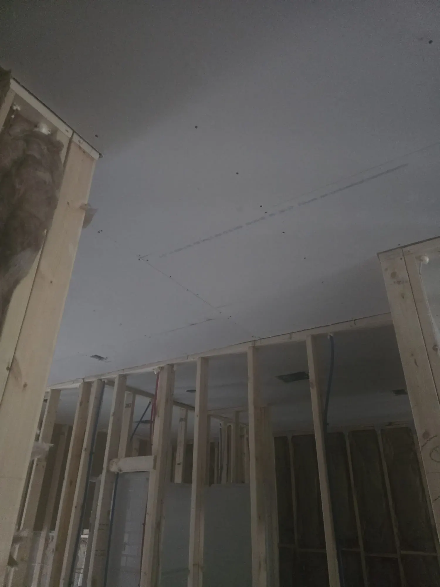 Drywall hung on a framed ceiling and walls before finishing
