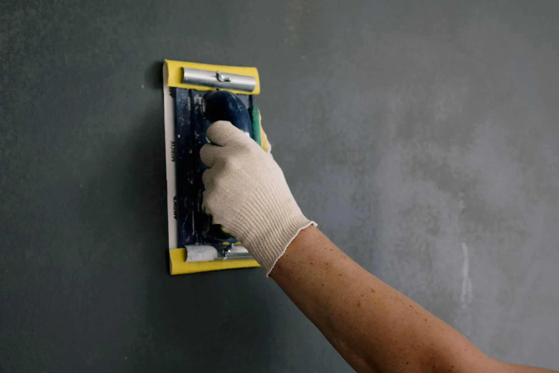 Sanding a drywall patch smooth in Lehigh Acres